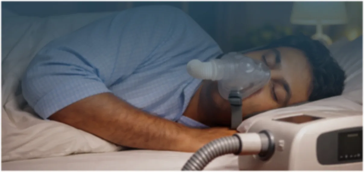 Patient sleeping with CPAP therapy device